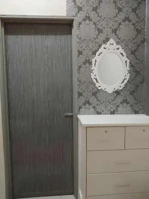 a bathroom with a mirror next to a door at Zah’ra Homestay in Kuala Lipis