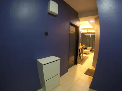 a kitchen with a blue wall and a white refrigerator at Qasturi Homestay Cameron in Cameron Highlands