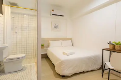 a bathroom with a bed and a toilet in a room at Minima 8 in George Town