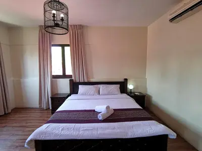 a bedroom with a bed with a stuffed animal on it at 8 Boutique By The Sea in George Town