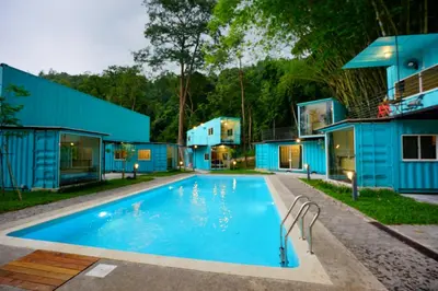 a swimming pool in front of a house at Sarang by the brook in Kuala Kubu Baharu