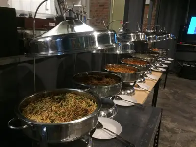 a row of metal pots filled with food at Sarang by the brook in Kuala Kubu Baharu