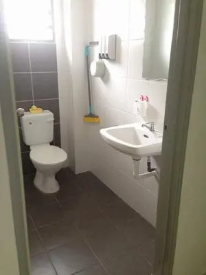 a bathroom with a toilet and a sink at NUHA HOMESTAY in Seri Iskandar