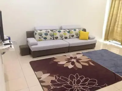 a living room with a couch and a rug at NUHA HOMESTAY in Seri Iskandar