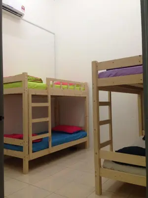 two bunk beds sitting next to each other in a room at NUHA HOMESTAY in Seri Iskandar