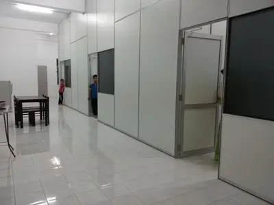 a hallway with doors and a table in a building at GERIK HOMESTAY in Gerik