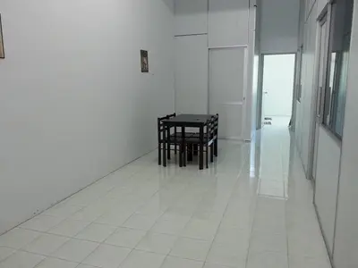 a white tiled floor with a table and chairs in a room at GERIK HOMESTAY in Gerik
