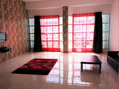 a living room with red windows and a table at GERIK HOMESTAY in Gerik