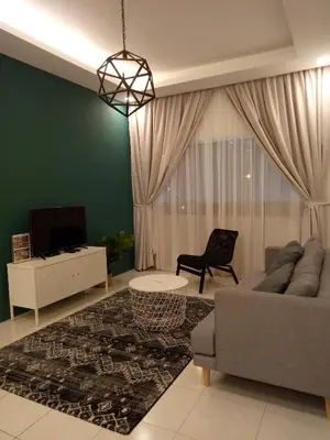 a living room with a couch and a tv at NATURE @ FOREST CAMERON 15 in Tanah Rata