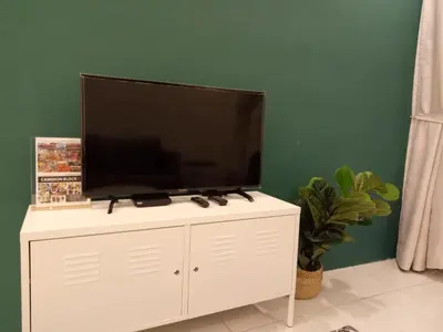 a flat screen tv sitting on top of a white cabinet at NATURE @ FOREST CAMERON 15 in Tanah Rata