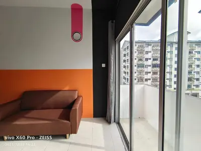 a brown chair in a room with a balcony at SKY PURPLE @CH in Tanah Rata