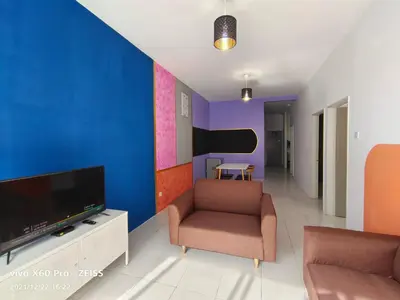 a living room with a tv and a couch and a chair at SKY PURPLE @CH in Tanah Rata