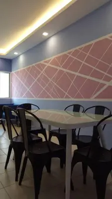 a dining room with a table and two chairs at SKY PURPLE @CH in Tanah Rata