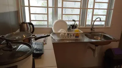 a kitchen counter with a sink and a sink at SKY PURPLE @CH in Tanah Rata