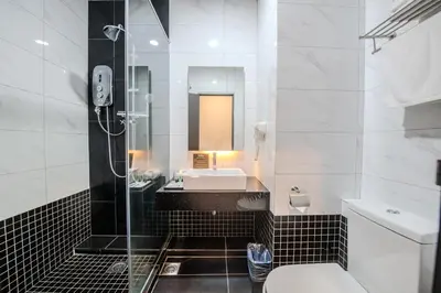 a bathroom with a shower and a sink and a toilet at O&G Hotel Parit Buntar in Parit Buntar
