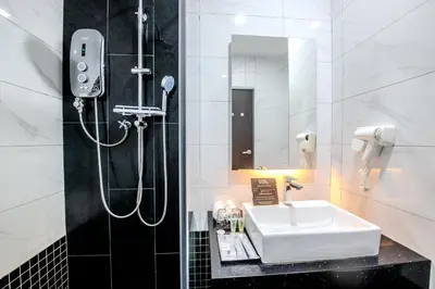 a bathroom with a sink and a shower at O&G Hotel Parit Buntar in Parit Buntar