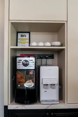 a kitchen with a coffee maker and a microwave at O&G Hotel Parit Buntar in Parit Buntar