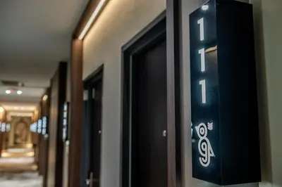 a door sign on the side of a hallway at O&G Hotel Parit Buntar in Parit Buntar
