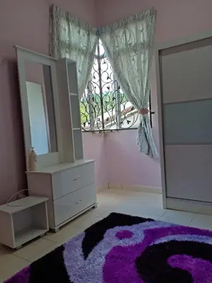 a bedroom with a mirror and a dresser and a window at Muslim Dinaim Homestay in Tanjung Malim