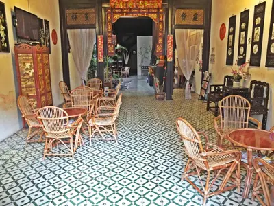 a dining room with tables and chairs and a doorway at Muntri House by Virtue Hospitality in George Town