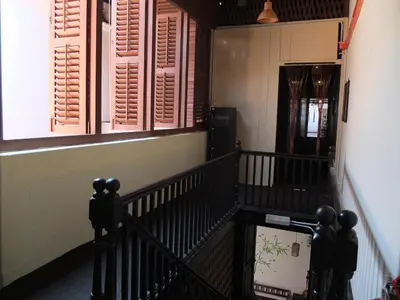 a staircase in a house with pink shutters at Muntri House by Virtue Hospitality in George Town