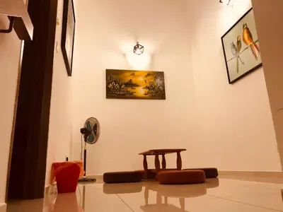 a room with a table and a fan at 2sty Villa - Walking Distance To The Beach in Pangkor