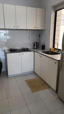 a kitchen with white cabinets and a sink at The Barn private home @ Sri Sayang Apartment in Batu Ferringhi