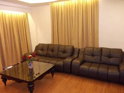 a living room with a couch and a coffee table at Bali Style Apartment @ Imperial Court in Cameron Highlands