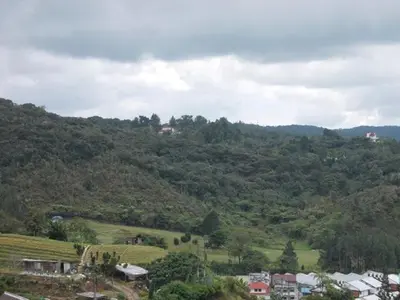 a view of a mountain with houses and a town at Bali Style Apartment @ Imperial Court in Cameron Highlands