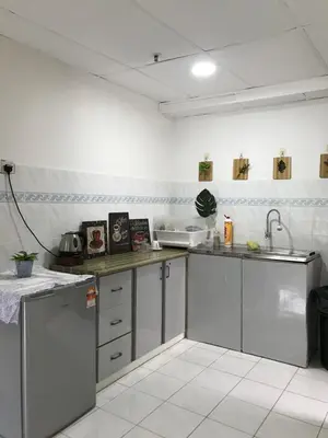 a kitchen with stainless steel cabinets and a sink at coralbay apartment pangkor island in Pangkor