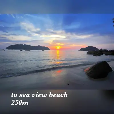 a sunset on the beach with the words to sea view new beach at coralbay apartment pangkor island in Pangkor