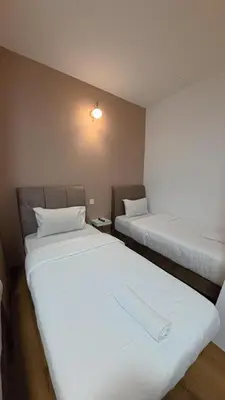 a room with two beds in a room at Nice Inn in George Town