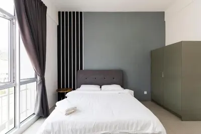 a bedroom with a large bed and a large window at DreamScape Studio @ Golden Hill Cameron in Cameron Highlands