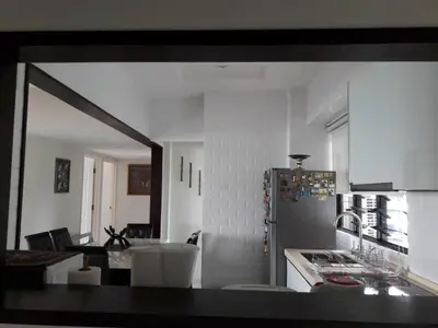 a kitchen with a counter and a refrigerator in it at Susie's VIP Resort Seaview Suite at Sri Sayang in Batu Ferringhi