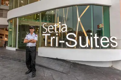 a police officer standing in front of a store at Cozy Home with Spectacular View in Bayan Lepas