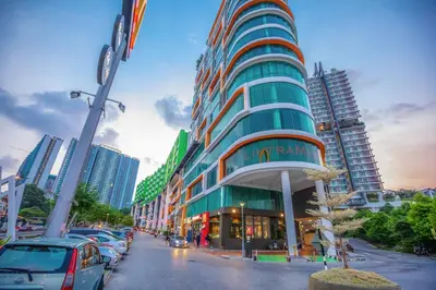 a tall building on a city street with cars parked at Cozy Home with Spectacular View in Bayan Lepas
