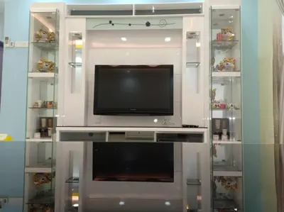 a entertainment center with a television in a room at Sekinchan Paddy via Seaview Home \u9ad8\u697c \u770b\u6d77 \u7a3b\u7530 \u6c11\u5bbf in Sekincan