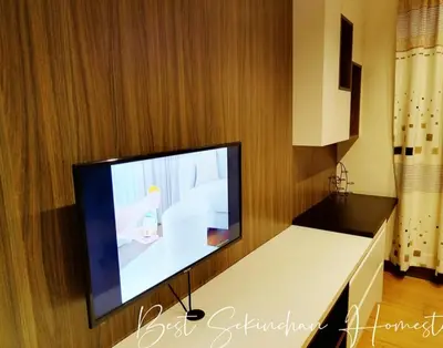 a living room with a flat screen tv on a wall at Sekinchan Paddy via Seaview Home \u9ad8\u697c \u770b\u6d77 \u7a3b\u7530 \u6c11\u5bbf in Sekincan