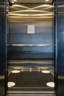 a metal elevator door with a sign on it at SAVV HOTEL in George Town
