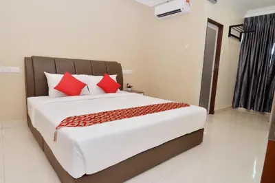 a bedroom with a large bed with red pillows at Hotel Raub Agro in Raub