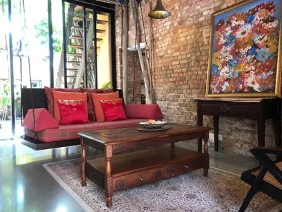 a living room with a red couch and a coffee table at Spices Hotel in George Town