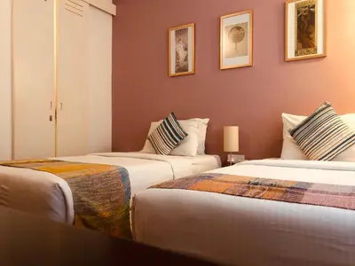 two beds in a hotel room with two at Spices Hotel in George Town