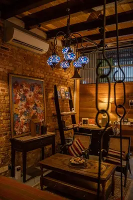 a living room with a table and blue lights at Spices Hotel in George Town