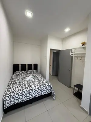 a bedroom with a bed in a white room at De Little Cabin - 7mins to Sunway Iost World of Tambun in Ipoh