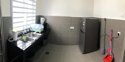 a small kitchen with a sink and a refrigerator at De Little Cabin - 7mins to Sunway Iost World of Tambun in Ipoh
