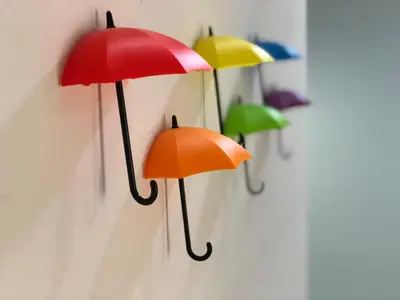 a group of umbrellas hanging on a wall at De Little Cabin - 7mins to Sunway Iost World of Tambun in Ipoh