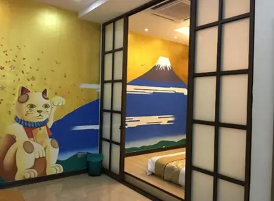 a room with a window with a cat painted on the wall at Sekinchan Theme Design Penthouse 16-30Ppax \u4e3b\u9898\u9876\u5c42\u516c\u5bd3\u6c11\u5bbf in Sekincan