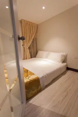 a bed in a room with a window at Sekinchan Theme Design Penthouse 16-30Ppax \u4e3b\u9898\u9876\u5c42\u516c\u5bd3\u6c11\u5bbf in Sekincan