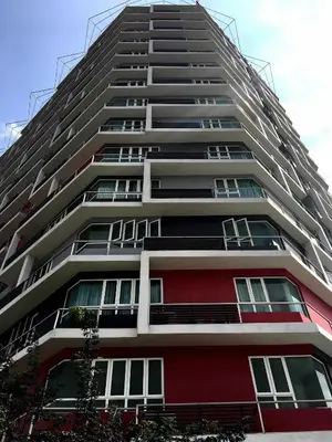a tall apartment building with red and white at Excellent Location Octagon Studio at Palo 101 Ipoh in Ipoh