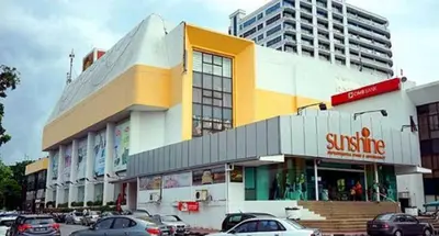 a building with cars parked in a parking lot at Super 8 Hotel @ Bayan Baru in Bayan Lepas